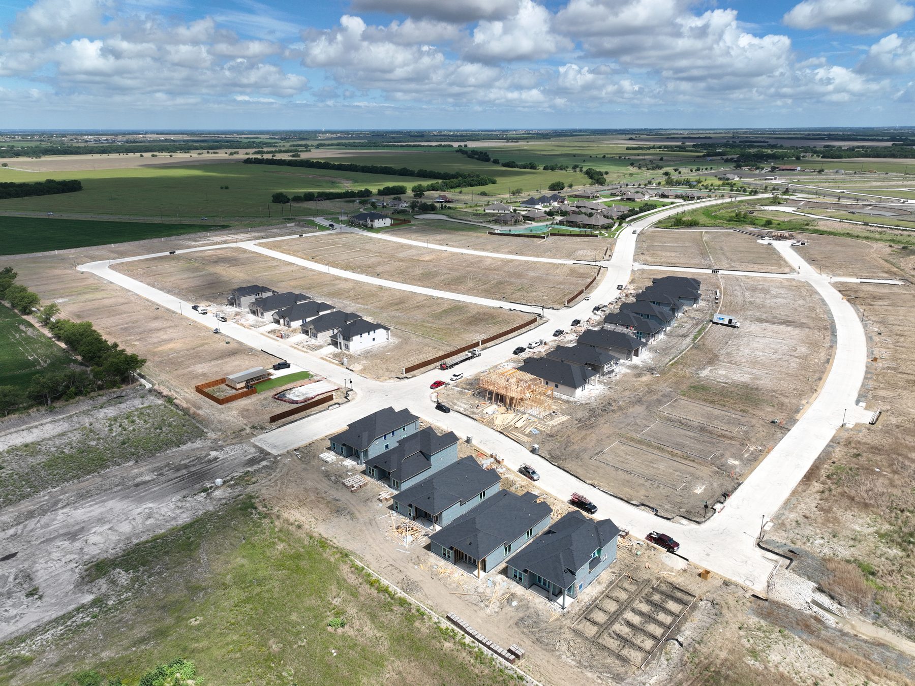 Aerial view of completed and framed homes lining neighborhood streets at Clearview Ranch Phase 1 in Royse City, Texas