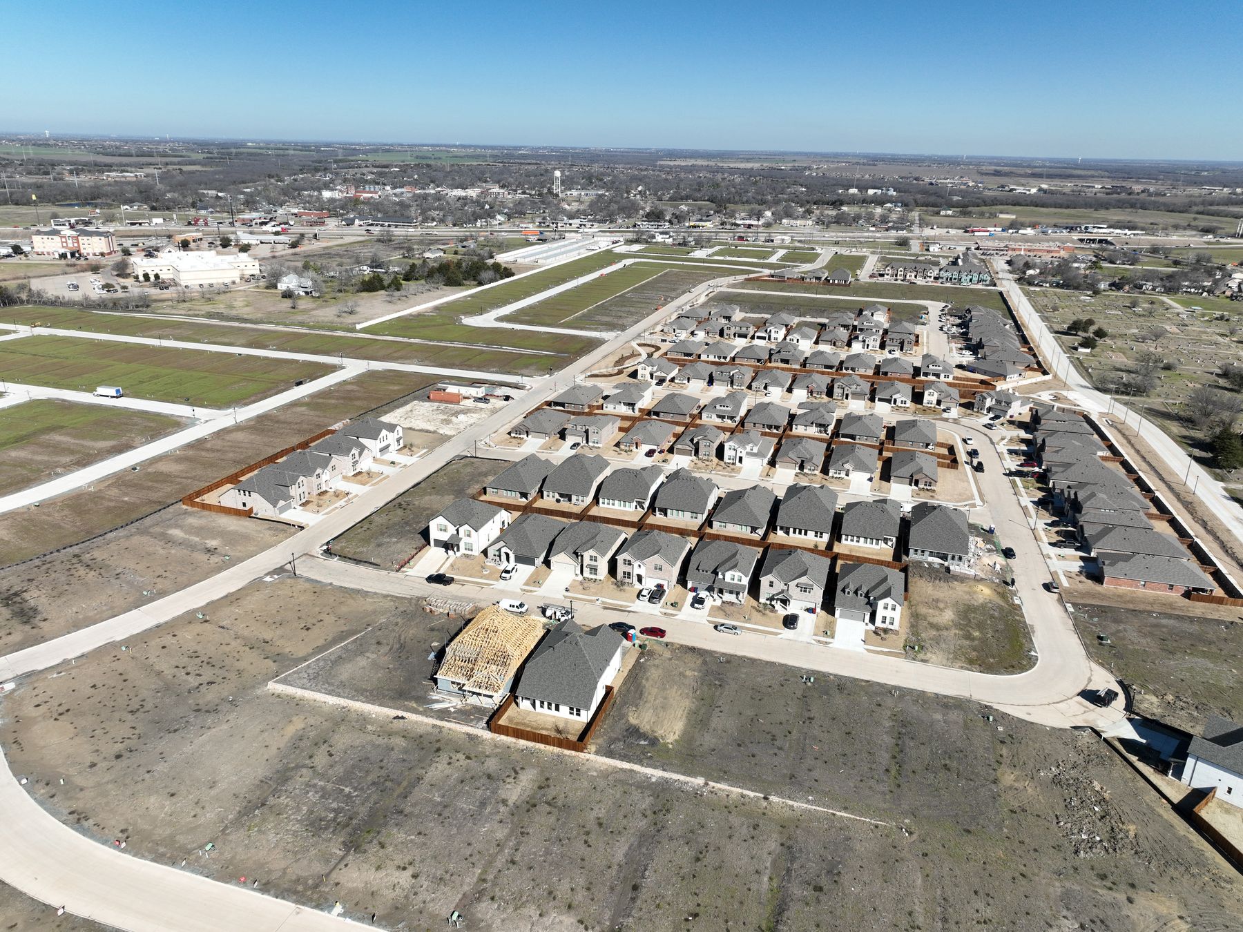 Aerial view of finished homes filling the streets of Liberty Crossing Phase 1 in Royse City, Texas, with downtown Royse City beyond